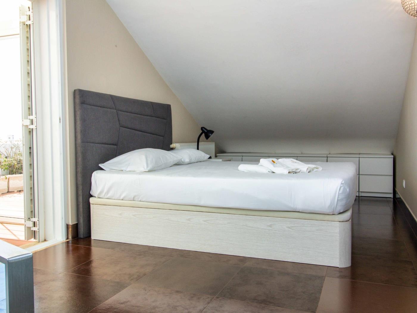 Upper duplex bedroom with bed and terrace access at Dunas Salgados Apartment